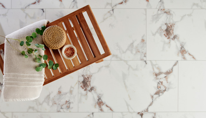 stone look tile in bathroom with bath tray